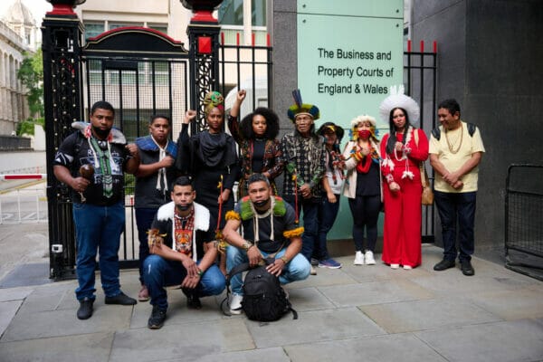 Indigenous people from Brazil protesting outside Courts in England