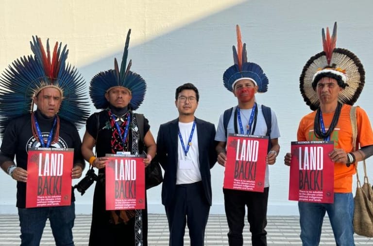 Felipe Hotta stands alongside Indigenous people at COP28